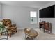 Cozy living room featuring an armchair, window, TV, cabinet and oval coffee table at 154 Cotton Field Dr, Statesville, NC 28677