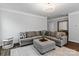 Comfortable living room features a plush gray sectional, neutral decor, and a stylish area rug at 154 Cotton Field Dr, Statesville, NC 28677