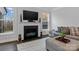 Cozy living room features a fireplace, large windows, and comfortable seating on a plush gray couch at 154 Cotton Field Dr, Statesville, NC 28677