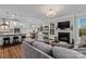 Open-concept living space with a modern kitchen, dining area, and cozy living room with a fireplace at 154 Cotton Field Dr, Statesville, NC 28677