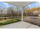 Covered patio featuring a hot tub and landscaped backyard at 154 Cotton Field Dr, Statesville, NC 28677