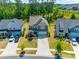 Stunning aerial view of a charming two-story home with a well-manicured lawn and inviting driveway at 1540 Striped Bass Ln, Clover, SC 29710