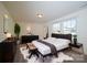 Modern bedroom with stylish decor, a comfortable bed, and ample natural light at 1540 Striped Bass Ln, Clover, SC 29710