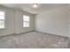 A sun-filled, carpeted bedroom with dual windows and neutral paint, creating a serene living space at 1540 Striped Bass Ln, Clover, SC 29710