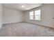 A bright bedroom with two windows providing natural lighting with carpeted flooring at 1540 Striped Bass Ln, Clover, SC 29710