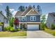 Charming two-story home featuring a two-car garage, brick accents, and a beautifully landscaped front yard at 1540 Striped Bass Ln, Clover, SC 29710