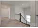 Carpeted hallway with railing looking over the stairway and a view from the window at 1540 Striped Bass Ln, Clover, SC 29710