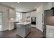 Charming kitchen features white cabinets, an island, stainless appliances, and hardwood floors at 1540 Striped Bass Ln, Clover, SC 29710