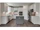 Modern kitchen featuring white cabinetry, stainless steel appliances, island, and hardwood flooring at 1540 Striped Bass Ln, Clover, SC 29710