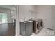 A convenient laundry room with washer, dryer, sink and cabinet at 1540 Striped Bass Ln, Clover, SC 29710