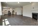 Open concept living space with fireplace, hardwood flooring, and modern kitchen with white cabinets at 1540 Striped Bass Ln, Clover, SC 29710