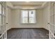 Office with hardwood flooring, tray ceiling, and natural light through large window and glass French doors at 1540 Striped Bass Ln, Clover, SC 29710