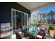 Inviting screened patio with an outdoor kitchen and dining area with a glass table at 1540 Striped Bass Ln, Clover, SC 29710