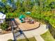 Community playground equipped with a slide and climbing structures, surrounded by trees at 1540 Striped Bass Ln, Clover, SC 29710