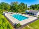 Aerial view of a fenced community pool with lounge chairs, tables, and a nearby community building at 1540 Striped Bass Ln, Clover, SC 29710