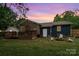 Relaxing backyard with a fire pit and wooden deck, perfect for entertaining at 1724 Virginia St, Monroe, NC 28110