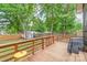 Inviting backyard deck overlooking green space, features a grill and a small bistro table at 1724 Virginia St, Monroe, NC 28110