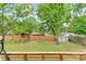 Spacious backyard featuring a playset with slide and swing, shed, and lush green grass at 1724 Virginia St, Monroe, NC 28110
