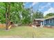 Beautifully landscaped backyard with a playset, fire pit, screened porch, and ample space for entertaining at 1724 Virginia St, Monroe, NC 28110