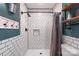 Bathroom showcasing a modern white tile shower with black trim and industrial shelving at 1724 Virginia St, Monroe, NC 28110