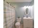 Bathroom featuring a shower with curtain, toilet, and a vanity with decorative plants and mirror at 1724 Virginia St, Monroe, NC 28110