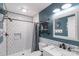 Stylish bathroom featuring a tiled shower, industrial shelving, modern fixtures, and a decorative mirror at 1724 Virginia St, Monroe, NC 28110