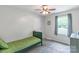 Neutral bedroom with a simple single bed, soft carpet, and natural lighting at 1724 Virginia St, Monroe, NC 28110