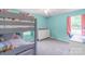 A bright bedroom featuring a bunk bed, dresser, carpeting, and ample natural light at 1724 Virginia St, Monroe, NC 28110