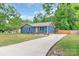 Lovely blue home with a long driveway and a well-maintained front lawn at 1724 Virginia St, Monroe, NC 28110