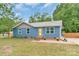 Charming single-story home with a well-manicured lawn and inviting yellow door at 1724 Virginia St, Monroe, NC 28110