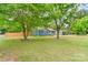 Charming blue house with well-manicured front yard, mature trees, and neat landscaping at 1724 Virginia St, Monroe, NC 28110