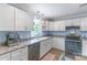 Bright kitchen with white cabinets, stainless steel appliances, and modern lighting at 1724 Virginia St, Monroe, NC 28110