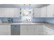 Bright kitchen with a view from the window over the stainless sink and white cabinets at 1724 Virginia St, Monroe, NC 28110
