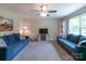 Bright living room with plush sofas, a ceiling fan, and a large window at 1724 Virginia St, Monroe, NC 28110