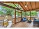 A screened-in porch offers comfortable seating, a ceiling fan, and views of the surrounding greenery at 1724 Virginia St, Monroe, NC 28110