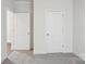 Carpeted bedroom showcases two interior doors, emphasizing accessibility and flow within the home at 2031 Skyhawk Dr, York, SC 29745