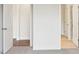 Hallway featuring carpet flooring, white walls and trim, with views of the wood floors in adjacent rooms at 2031 Skyhawk Dr, York, SC 29745