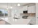 Modern kitchen with white cabinets, stainless steel appliances, quartz countertops, and a center island at 2031 Skyhawk Dr, York, SC 29745