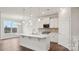Bright open-concept kitchen featuring an island, stainless steel appliances, and pendant lighting at 2031 Skyhawk Dr, York, SC 29745