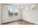 Cozy dining area featuring hardwood floors, natural light, and a modern chandelier at 2053 Skyhawk Dr, York, SC 29745