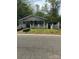 Charming bungalow-style house with a cozy front porch and white picket fence at 216 Maple St, Statesville, NC 28677