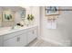 Bathroom with a double sink vanity, decorative mirror, and decorative rug on tile floor at 222 Giant Oak Ave, Statesville, NC 28677
