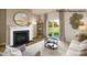 Bright living room with a fireplace, hardwood floors, and sliding glass doors to the backyard at 222 Giant Oak Ave, Statesville, NC 28677