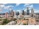 Stunning aerial view of the city skyline on a sunny day with a vibrant blue sky and scattered white clouds at 222 S Caldwell St # 1909, Charlotte, NC 28202
