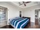 Comfortable bedroom featuring a modern ceiling fan and ensuite bathroom access at 222 S Caldwell St # 1909, Charlotte, NC 28202
