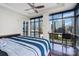 Bedroom with floor-to-ceiling windows overlooking the city, dark hardwood floors, and ceiling fan at 222 S Caldwell St # 1909, Charlotte, NC 28202