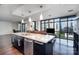 Gourmet kitchen with an island, granite countertops, stainless steel appliances, and city views at 222 S Caldwell St # 1909, Charlotte, NC 28202