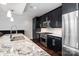 Modern kitchen featuring stainless steel appliances, granite counters and dark wood cabinets at 222 S Caldwell St # 1909, Charlotte, NC 28202