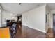 Open-concept living area featuring hardwood floors and dark kitchen cabinets at 222 S Caldwell St # 1909, Charlotte, NC 28202