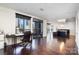 Spacious living room with hardwood floors, office area, and balcony access at 222 S Caldwell St # 1909, Charlotte, NC 28202